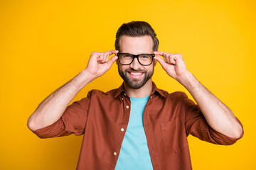 Portrait of satisfied young person arms touch glasses unbuttoned shirt isolated on vibrant yellow color background