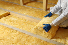 Worker Insulate The Attic With Mineral Wool