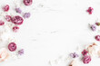 Flowers composition. White and purple flowers on marble background. Flat lay, top view