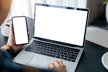 computer screen,cell phone blank mockup.hand woman work using laptop texting mobile.with white background for advertising,contact business search information on desk in cafe.marketing,design