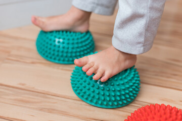 Sports balancing hemisphere for foot massage. Caring for the health of the worker, prevention of plascostopia and leg health. Training with children acupressure foot massage