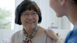 © ChayTee - Young asian woman or nurse home care hand on senior grandmother shoulder give support empathy to elderly lady or older people in assisted living homecare mental health sick relief concept.