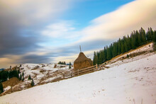 Haystack On Mountain Slope Under Moving Clouds At Winter Day, Carpathian Mountains, Ukraine