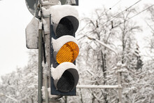 A Working Traffic Light On A City Street In Winter.The Yellow Light Is On Get Ready To Go.