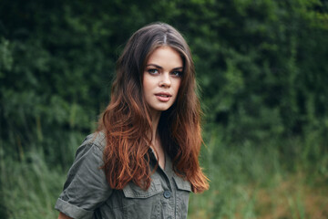 Portrait of a woman nature Long hair green suit forest vacation 