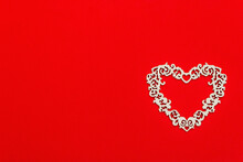Festive Composition With Openwork White Heart On Red Background