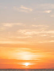 sunset sky vertical over sea in the evening with majestic colorful orange sunlight clouds, nature la
