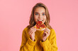 © Drobot Dean - Excited beautiful blonde girl eating pizza at camera