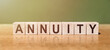 ANNUITY word written on wooden blocks on wooden table. Concept for your design.