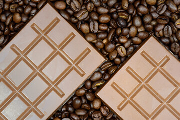 Background and texture of two bars of chocolate lying on brown coffee beans