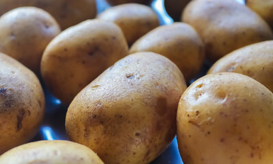 Wall Mural - Closeup of a heap of raw potatoes, kitchen concept