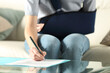 © PheelingsMedia - Handicapped woman with sling signing contract