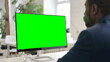 © stockbakers - Man Using Desktop with Green Chroma Key Screen