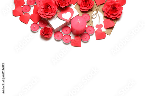 Several pink wax candles, gifts, 3D handmade red paper roses and hearts on white background. Love, Valentine's, mother's, women's day, relations, romantic, wedding concept 