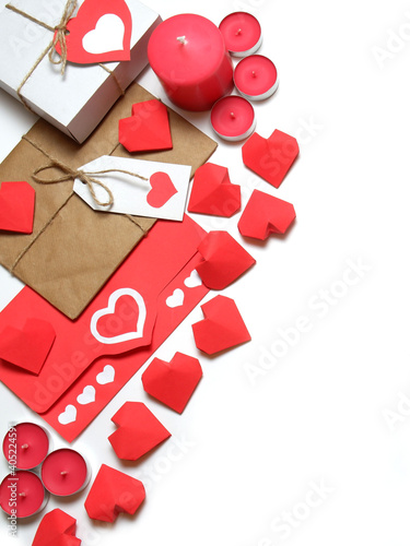Gifts, pink candles, tied with twine with bows and labels, 3D red paper hearts, love letter in red envelope with hearts on white background isolated. Love, Valentine's, relations, romantic concept 