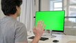 © stockbakers - Video Call by Businessman on Desktop with Green Chroma Key Screen,