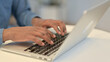 © stockbakers - African Man Typing on Laptop Keyboard, Close Up