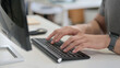 © stockbakers - Hands of Young Man Typing on Keyboard, Close Up
