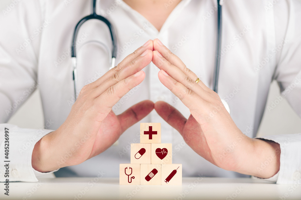 Hand arranging wood block stacking with the healthcare medical icon. Health insurance - health concept