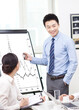 © eastfenceimage - Young Business man presenting graph in meeting