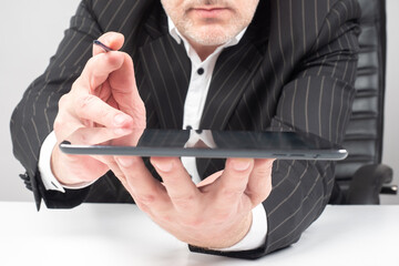 Poster - man holds a tablet up screen. businessman holds electronic tablet in his hands. concept - businessma