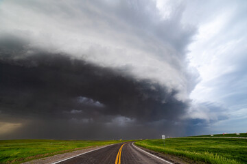 Wall Mural - storm clouds over a road