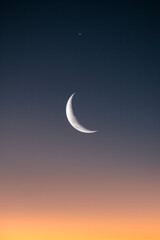 half moon in sunset sky