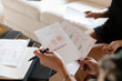 © Emma Innocenti/Westend61 - Professional female designer showing project to client while sitting at home office