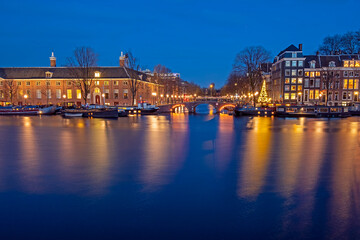 Poster - City scenic from Amsterdam by night in the Netherlands