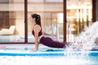 © Jose Carlos Ichiro/Westend61 - Female instructor doing Cobra pose on paddleboard over swimming pool