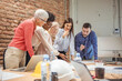 © Dragana Gordic - Shot of a group of businesspeople sitting together in a meeting. Group of business persons in discussion. Business people working in the office.