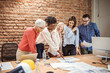 © Dragana Gordic - Shot of a group of businesspeople sitting together in a meeting. Group of business persons in discussion. Business people working in the office.