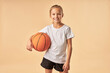 © Friends Stock - Cheerful girl basketball player holding game ball
