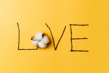 Creative Flat Lay Of Word Love On Yellow Background With Baumwolle