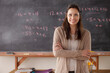 © Rob Lewine/Tetra Images - Portrait of teacher with blackboard in background