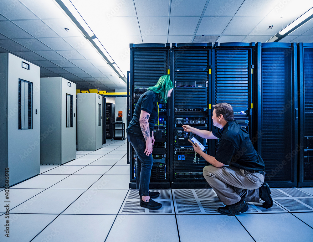 Co-workers in data center server room Stock Photo | Adobe Stock