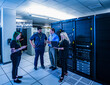 © Erik Isakson - Four co-workers having a meeting in data center