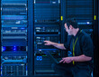 © Erik Isakson - Employee pointing at server rack in data center