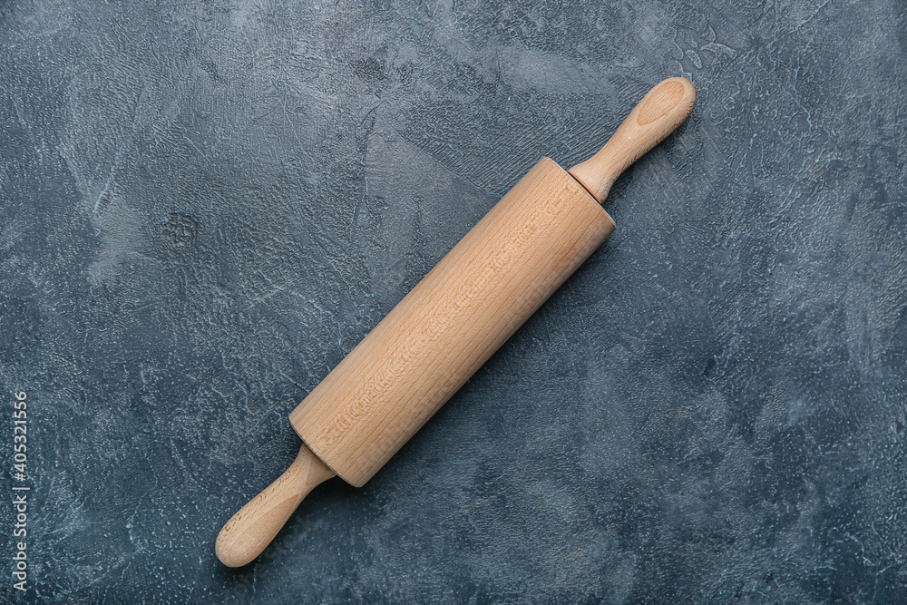 Wooden rolling pin on dark background