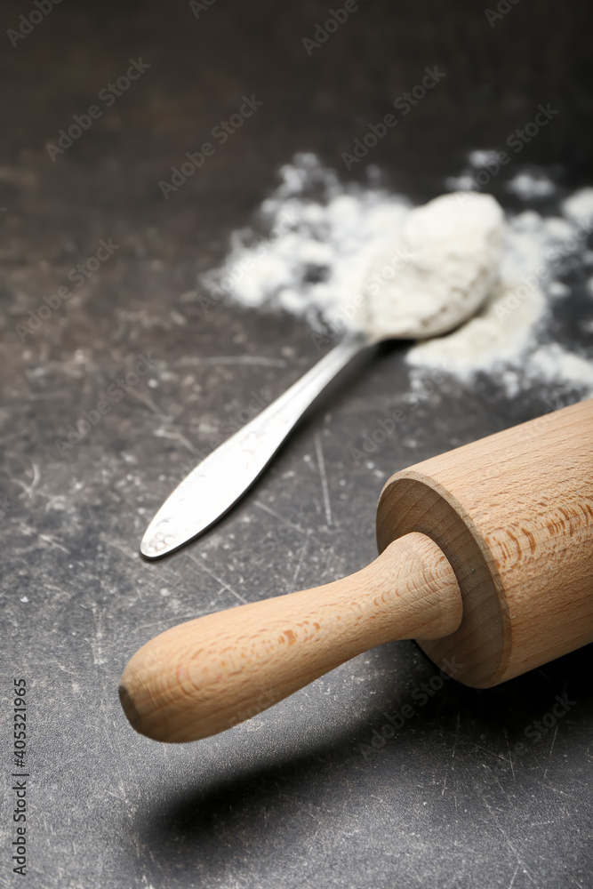 Wooden rolling pin on dark background