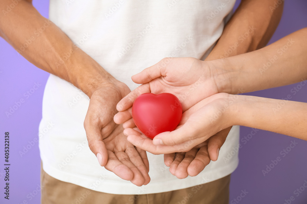 Hands of family with heart