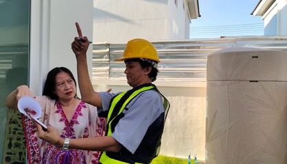 Men architect and women checking the house.