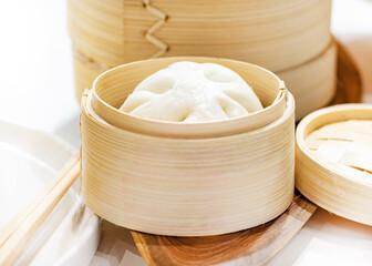 Wall Mural - Chinese steamed pork buns, Steamed bun served in wooden basket