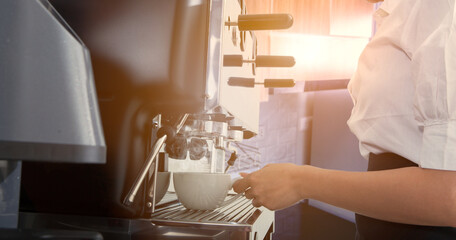 Wall Mural - Coffee machine pours fresh espresso into the cups