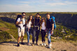 © Studio Romantic - Portrait of a happy and joyful group of hikers on a background of mountain countryside.