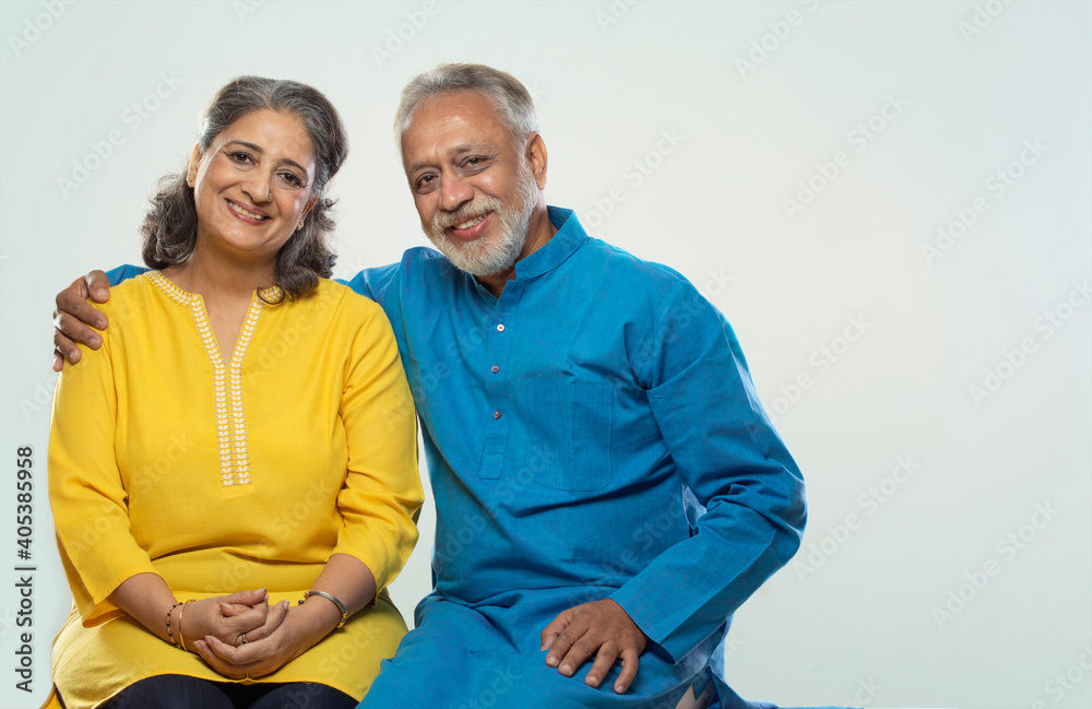 AN SENIOR COUPLE HAPPILY LOOKING AT CAMERA AND SMILING Stock Photo ...