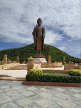 Buddha Statue Against Cloudy Sky