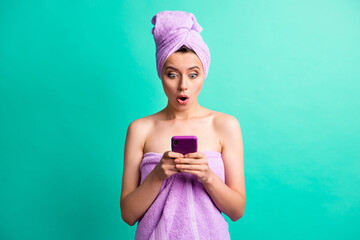 Sticker - Photo of amazed young lady hold telephone hands check time late wear violet towels isolated teal color background