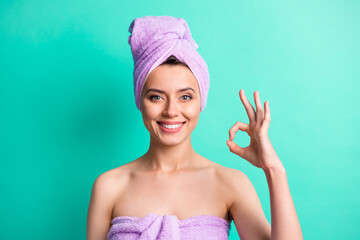 Sticker - Photo of adorable lady after taking shower show okey symbol express approval wear violet towels isolated teal color background