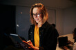 © StratfordProductions - Portrait of a smiling young business woman using digital tablet in modern office
